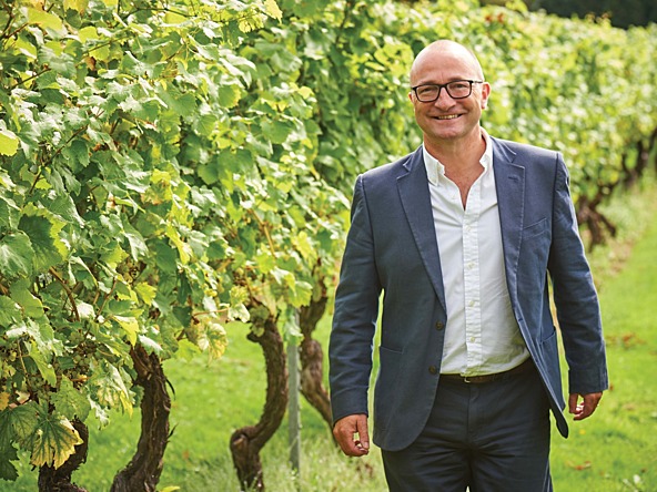 a photo of andrew carter standing in a vineyard